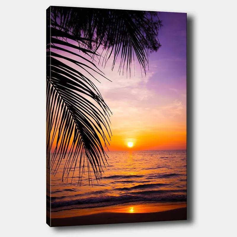 Canvas taulu 70x100 cm - Auringonlasku meren yllä, palmuja etualalla, Violetti / Oranssi / Keltainen