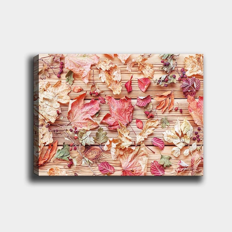 Canvas taulu 70x100 cm - Eriväristen syksynlehtien kokoelma puupinnalla - Punainen / Keltainen / Vihreä - Sisustustuotteet - Taulu & taide - Canvas-taulu