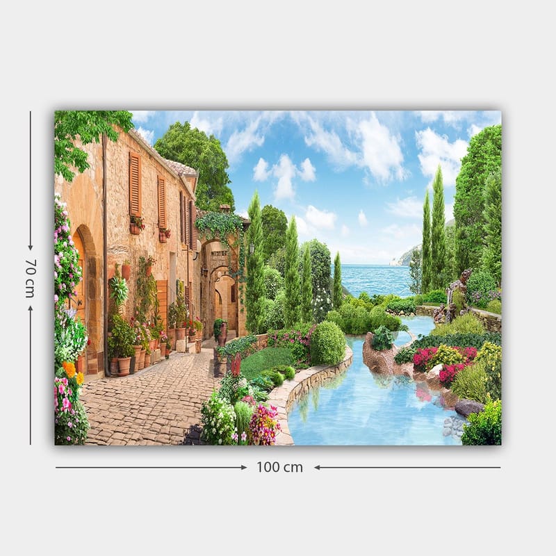 Canvas taulu 70x100 cm - Idyllinen maaseutukylä kukkien, puiden ja kimaltelevan järven taustalla - Vihreä / Sininen / Terrakotta - Sisustustuotteet - Taulu & taide - Canvas-taulu