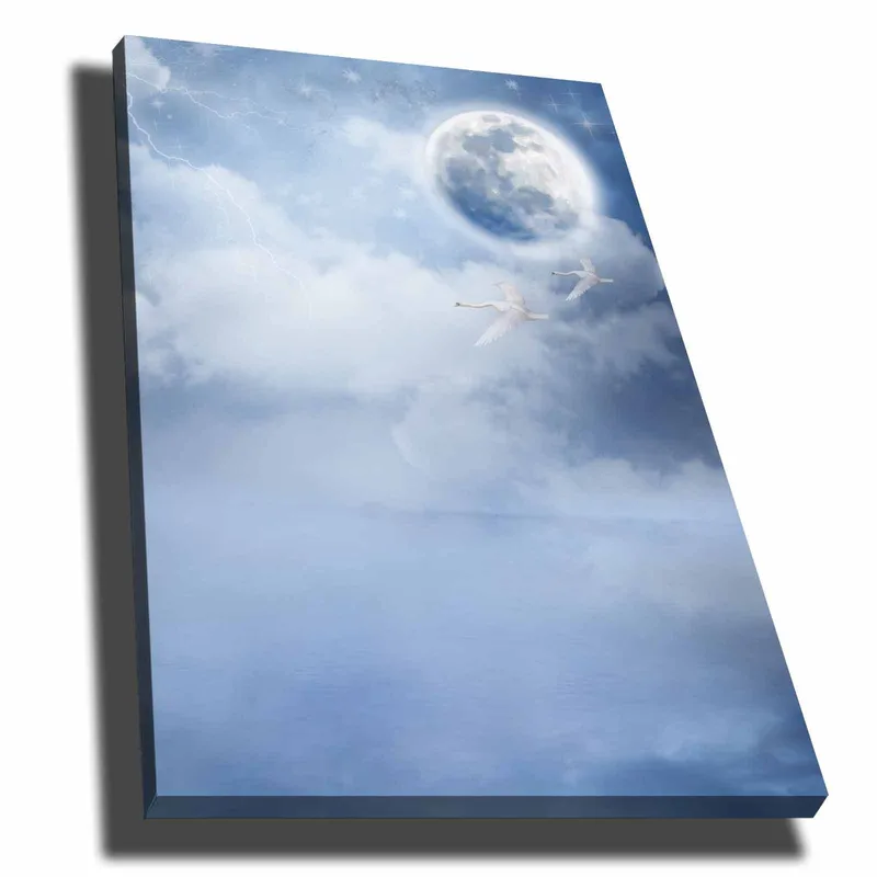 Canvas taulu 70x100 cm - Kaksi joutsenta lentää suuren kuun alla unenomaisella, pilvisellä taivaalla, Vaaleansininen / Valkoinen / Tummansininen