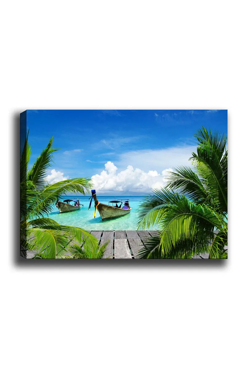 Canvas taulu 70x100 cm - Kaksi venettä kirkkaassa turkoosissa vedessä palmujen ja puisen laiturin ympäröimänä, Turkoosi / Vihreä / Sininen