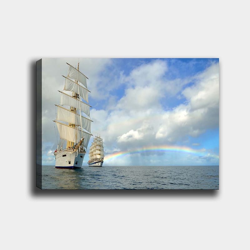 Canvas taulu 70x100 cm - Kaksi purjevenettä navigoimassa tyynellä merellä sinisen taivaan, pilvien ja sateenkaaren alla, Valkoinen / Sininen / Harmaa