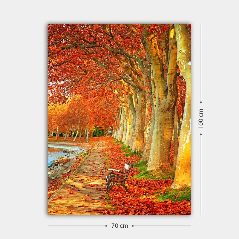 Canvas taulu 70x100 cm - Kaunis syysmaisema penkillä puiden reunustamalla kujalla, jossa on kimaltelevia punaisia ja oransseja lehtiä. - Punainen / Oranssi / Keltainen - Sisustustuotteet - Taulu & taide - Canvas-taulu