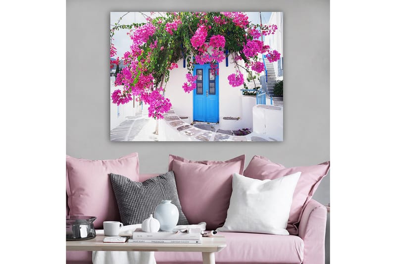 Canvas taulu 70x100 cm - Kaunis valkoinen rakennus sinisellä ovella, jota ympäröivät violetit kukat - Violetti / Sininen / Vihreä - Sisustustuotteet - Taulu & taide - Canvas-taulu