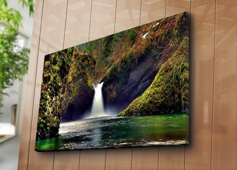 Canvas taulu 70x100 cm - Kaunis vesiputous virtaa alas vihreiden kallioiden välistä luonnonkauniissa ympäristössä - Vihreä / Sininen / Ruskea - Sisustustuotteet - Taulu & taide - Canvas-taulu