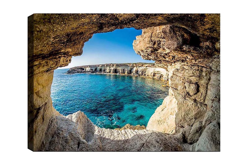 Canvas taulu 70x100 cm - Näkymä kallionkielekkeen läpi kohti kirkasta sinistä merenrantaa, Sininen / Beige / Valkoinen