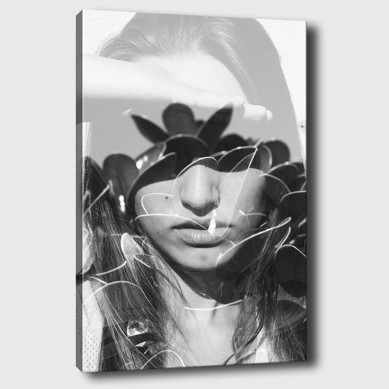 Canvas taulu 70x100 cm - Nainen käsi otsallaan, tyyliteltyjen kasvimuotojen ympäröimänä, Musta / Valkoinen