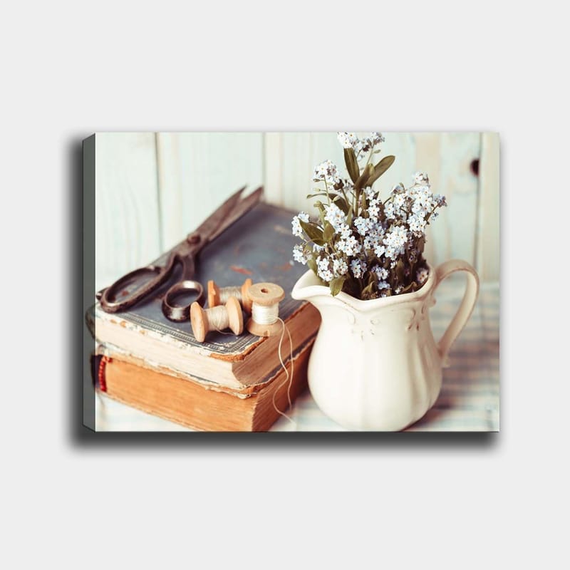 Canvas taulu 70x100 cm - Rauhallinen sommitelma kannusta, kukista, kirjasta ja ompeluvälineistä, Vaaleansininen / Beige / Vihreä