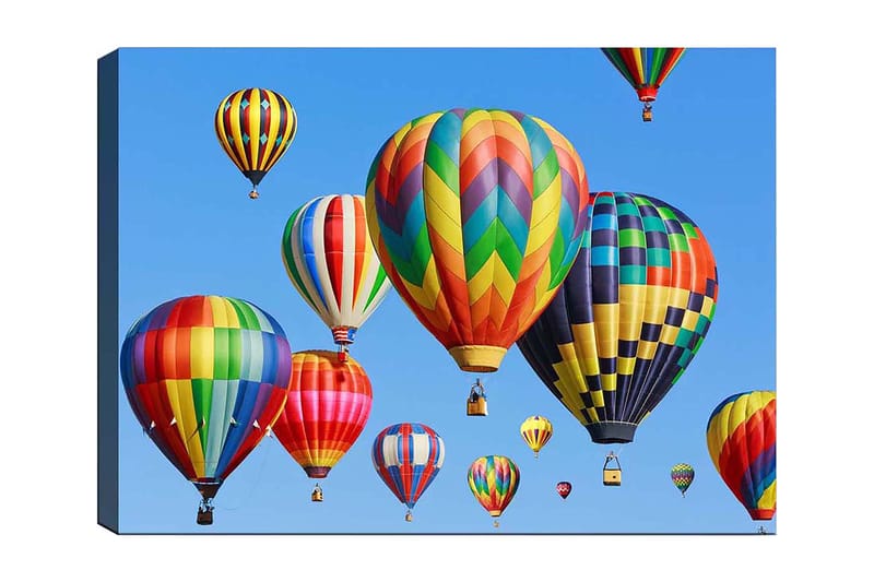 Canvas taulu 70x100 cm - Useita värikkäitä kuumailmapalloja leijumassa kirkkaalla sinisellä taivaalla, Punainen / Vihreä / Keltainen