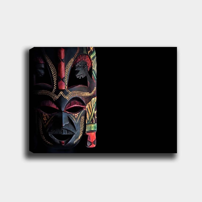 Canvas taulu 70x100 cm - Värikäs afrikkalainen naamio yksityiskohtaisilla kuvioilla ja ilmeikkäillä piirteillä, Musta / Punainen / Vihreä