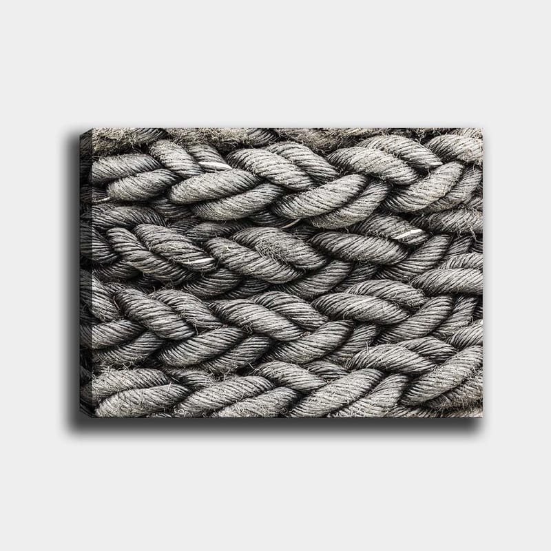 Canvas taulu 70x100 cm - Yksityiskohtainen lähikuva punotusta köydestä, jonka tekstuuri korostaa sen rakennetta ja materiaalia, Harmaa / Musta