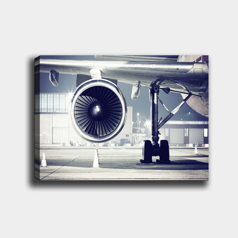 Canvas taulu 70x100 cm - Yksityiskohtainen näkymä lentokoneen moottorista ja sen alustasta lentokentällä - Harmaa / Musta / Hopea - Sisustustuotteet - Taulu & taide - Canvas-taulu