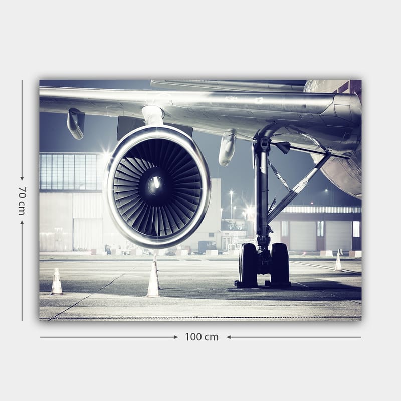 Canvas taulu 70x100 cm - Yksityiskohtainen näkymä lentokoneen moottorista ja sen alustasta lentokentällä - Harmaa / Musta / Hopea - Sisustustuotteet - Taulu & taide - Canvas-taulu