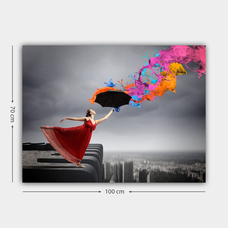 Canvas taulu 70x100 cm - Punamekkoinen nainen seisoo reunalla sateenvarjo kädessään, ja siitä suihkuaa värikkäitä maalisuihkuja - Punainen / Musta / Oranssi - Sisustustuotteet - Taulu & taide - Canvas-taulu