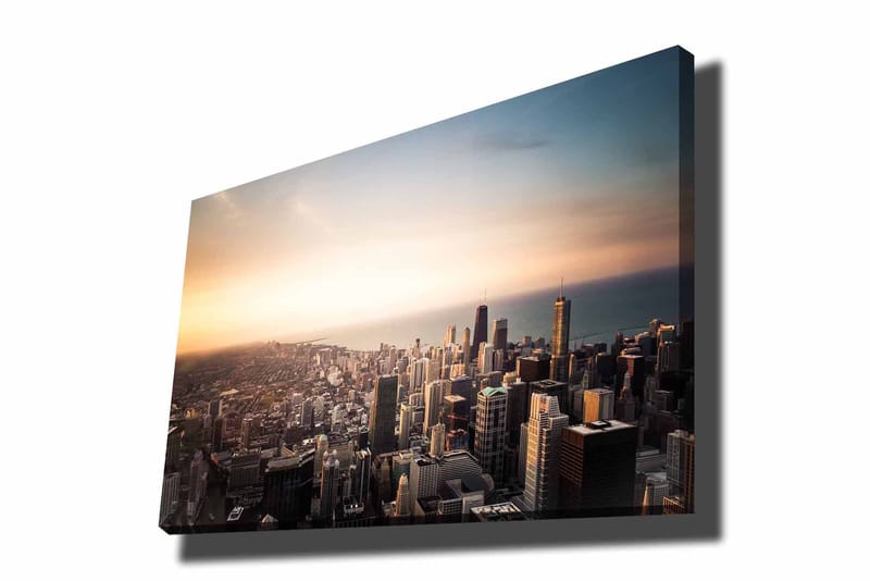 Canvas taulu 70x100 cm - Panoraamanäkymä kaupunkiin korkeine pilvenpiirtäjineen ja dramaattisen tunnelman luovalla auringonlaskulla, Sininen / Oranssi / Harmaa