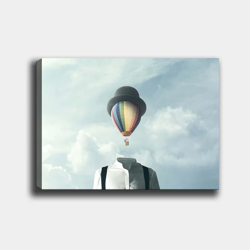 Canvas taulu 70x100 cm - Päätön mies valkoisessa paidassa ja mustassa hatussa, värikäs kuumailmapallo leijumassa yläpuolella, Valkoinen / Musta / Sateenkaari