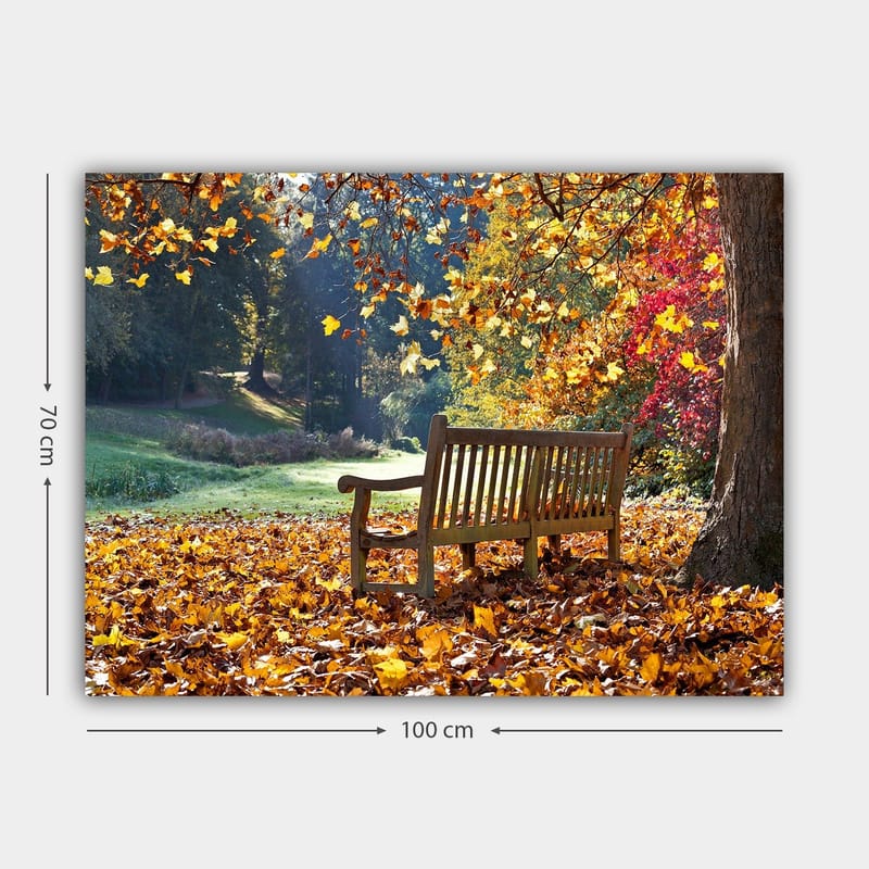 Canvas taulu 70x100 cm - Penkki värikkäiden syksynlehtien ympäröimänä luonnonkauniissa ympäristössä - Oranssi / Keltainen / Punainen - Sisustustuotteet - Taulu & taide - Canvas-taulu