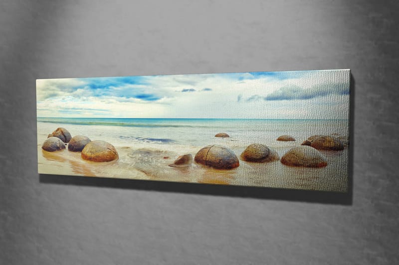 Canvas-taulu 80x30 cm - Pyöreitä kiviä rannalla, taustalla meri ja taivas - Sininen / Beige / Harmaa - Sisustustuotteet - Taulu & taide - Canvas-taulu