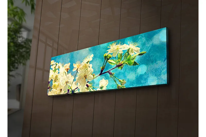 Canvas-taulu LED-valaistuksella 30x90 cm - Kukkivia kirsikanoksia vaaleansinistä taustaa vasten, Valkoinen / Vaaleansininen / Vihreä