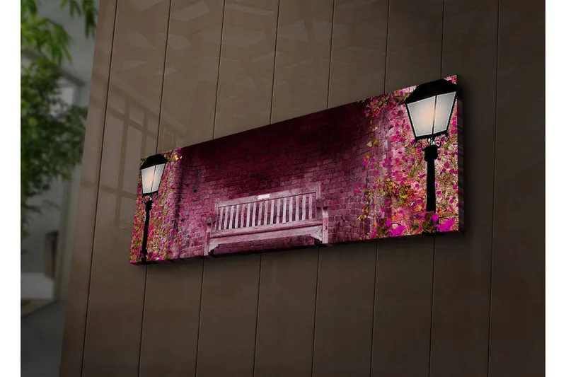 Canvas-taulu LED-valaistuksella 30x90 cm - Romanttinen puistonpenkki kukkivien kasvien ympäröimänä, Vaaleanpunainen / Vihreä / Ruskea