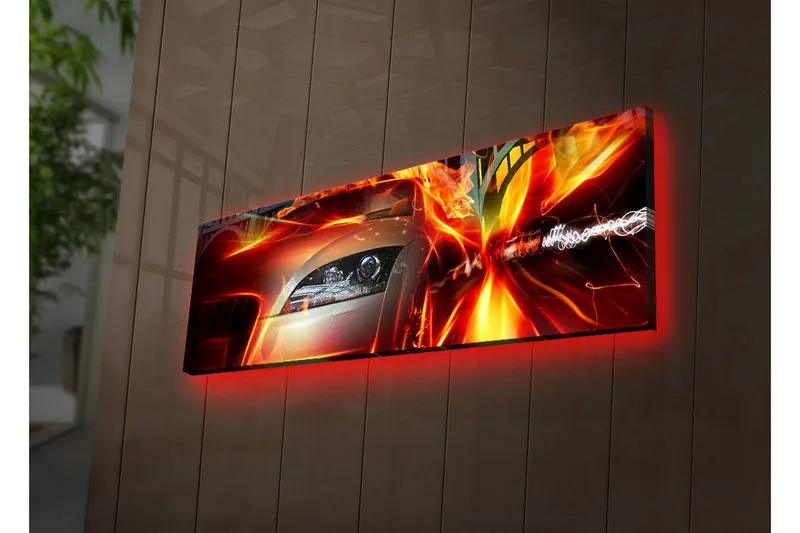 Canvas-taulu LED-valaistuksella 30x90 cm - Urheiluauto liikkeessä dynaamisilla valotehosteilla, Punainen / Oranssi / Musta