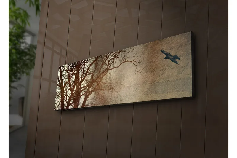 Canvas-taulu LED-valaistuksella 30x90 cm - Puun siluetti ja lennossa oleva lintu pehmeästi sävytettyä taustaa vasten, Tummanruskea / Beige / Musta