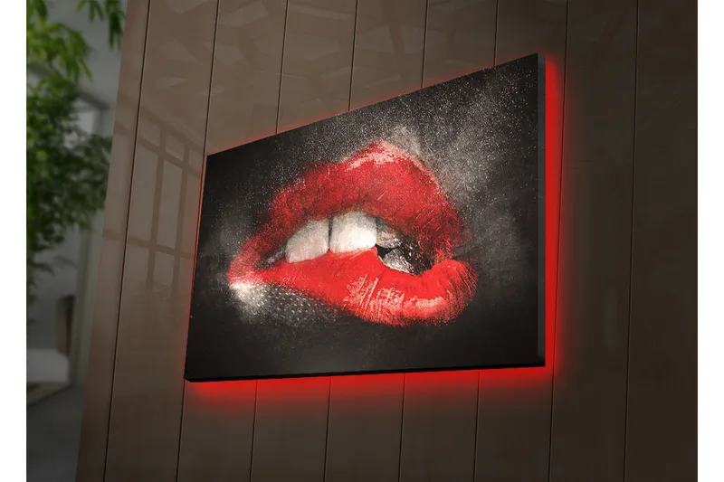 Canvas-taulu LED-valaistuksella 45x70 cm - Aistilliset punaiset huulet dramaattisella kontrastilla tummaa taustaa vasten, Punainen / Musta