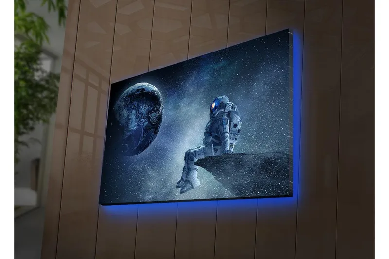 Canvas-taulu LED-valaistuksella 45x70 cm - Astronautti istuu kivellä ja katsoo Maata avaruudessa - Tummansininen / Harmaa / Valkoinen - Sisustustuotteet - Taulu & taide - Canvas-taulu