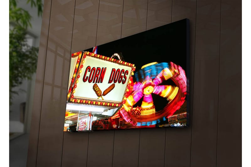 Canvas-taulu LED-valaistuksella 45x70 cm - Kirkas ja värikäs kyltti, jossa teksti CORN DOGS ja pyörivä karuselli taustalla, Punainen / Keltainen / Sininen