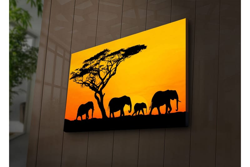 Canvas-taulu LED-valaistuksella 45x70 cm - Norsujen siluetit auringonlaskua vasten, Oranssi / Musta