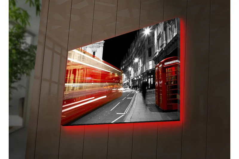 Canvas-taulu LED-valaistuksella 45x70 cm - Punainen kaksikerroksinen bussi liikkeessä mustavalkoisella kaupunkikadulla, Punainen / Musta / Harmaa